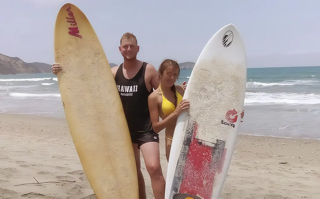 Vanessa and Matheo with surfboards